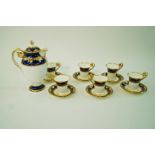 A Minton porcelain coffee service in Empire style, decorated with raised gilding on a blue ground,