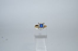 A synthetic sapphire and diamond cluster ring, stamped '18ct', finger size M1/2, 2.