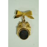 An early 20th century gold, bloodstone and carnelian spinning fob,