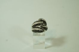 A diamond and black diamond dress ring, stamped '375',