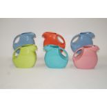 Six mid 20th century American "Fiesta" jugs, each of moulded Art Deco form, in multiple colours,