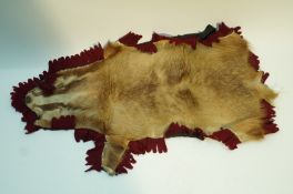 An early 20th century Badger skin rug, mounted by “Army & Navy C.S.L. No.