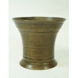 A 19th century bronze mortar with flared rim and foot, 9.5cm high, 10.