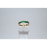 An enamelled ring, of waved edge, in green enamel, stamped '750', finger size P, 2.