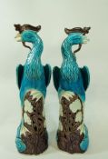 A pair of mid 20th century Chinese ceramic models of birds, in a blue tin glaze,