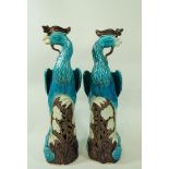 A pair of mid 20th century Chinese ceramic models of birds, in a blue tin glaze,