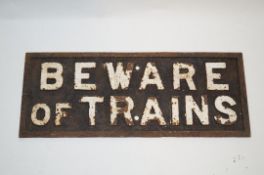 A late 19th century cast iron "Beware of trains" sign, 24.