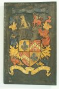 A 20th century carved  armorial wall plaque, painted in colours on a black ground 56cm high,