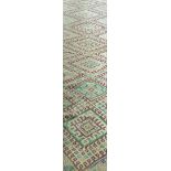 A  20th century  Berber woven runner with geometric repeating patterns on an ivory, field,