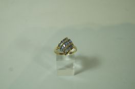 A tanzanite and diamond 9 carat gold dress ring, with three diagonal rows of tanzanite,