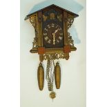 A Victorian Black Forest cuckoo clock of traditional form with painted cuckoo appearing from the