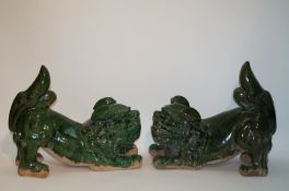 A pair of Chinese earthenware dogs of Fo, both with translucent green glaze, 50cm high,