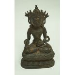 A Sino-Tibetan bronze figure of Buddha on a lotus plinth, some traces of gilding. 27.