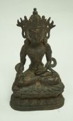 A Sino-Tibetan bronze figure of Buddha on a lotus plinth, some traces of gilding. 27.