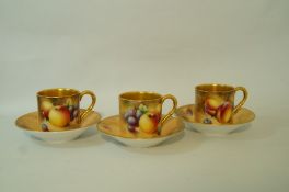 A set of three late 20th century Royal Worcester cabinet coffee cups and saucers,