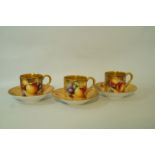 A set of three late 20th century Royal Worcester cabinet coffee cups and saucers,