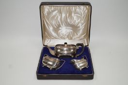 A three piece silver tea service, London 1929, in the Georgian style, monogrammed, 1128g (36.