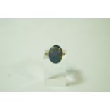 A black opal ring, the shallow cabochon to a carved shouldered mount, finger size H, 3.