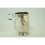 A silver mug, inscribed, 8cm high, 66g (2.