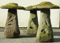 A set of three staddle stones and caps,  68cm high,