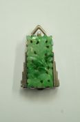 A 1930s jade dress clip, the rectangular carved and pierced panel,