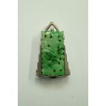 A 1930s jade dress clip, the rectangular carved and pierced panel,