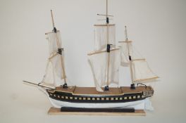 A 20th century model of a Man O War, with three masts, on rectangular plinth titled H.M.S.