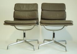 A pair of grey Eames office chairs, retailed by Herman Miller,