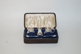 A three piece silver cruet set, by Walker & Hall, Birmingham 1927, comprising a mustard pot,