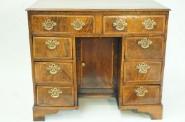 A George III style walnut kneehole desk,