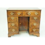 A George III style walnut kneehole desk,