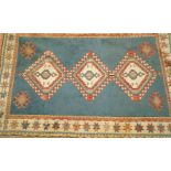 A decorative rug with  three medallions on a blue field within three borders 130cm wide,