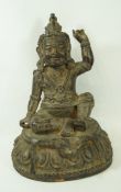 A Sino-Tibetan bronze figure of a deity seated on a lotus plinth, some traces of gilding, 25.