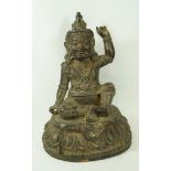 A Sino-Tibetan bronze figure of a deity seated on a lotus plinth, some traces of gilding, 25.