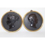 A pair of relief portrait busts of Prince Albert and another of Queen Victoria,