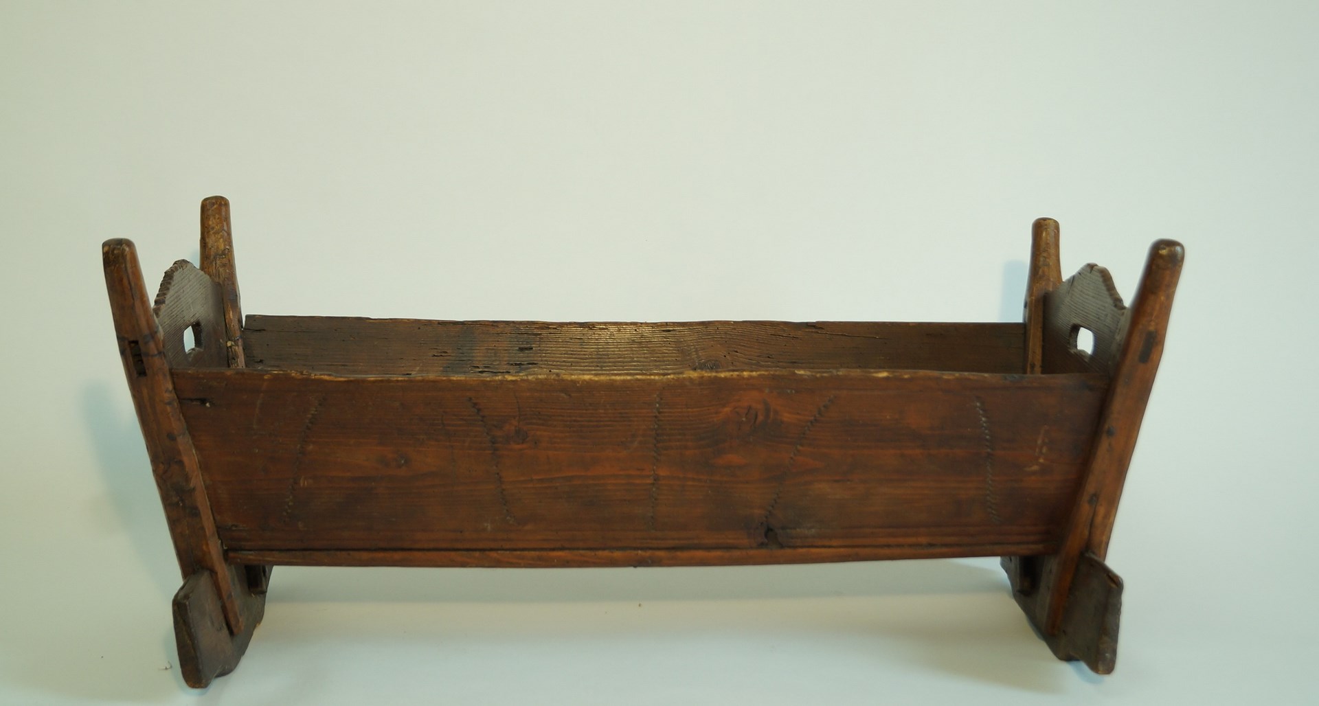 A Scandinavian crib, of wooden form, 40cm high,