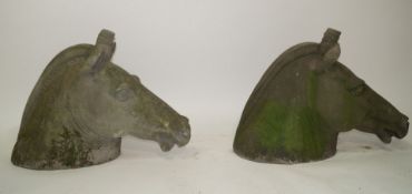 A pair of cast stone horses heads, after the antique,