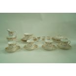 A Royal Worcester harlequin breakfast service, printed in brown with scrolling leaves,