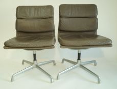 A pair of grey Eames office chairs, retailed by Herman Miller,