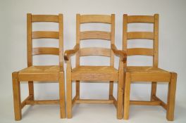 A set of ten oak dining chairs with ladder backs, rush seats and square legs,