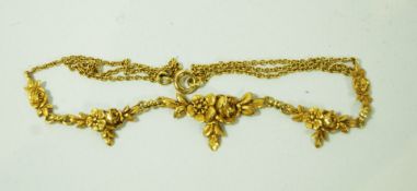 An 18 carat gold necklace, with a cast flower head frontispiece, 38.5cm long, 7.