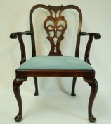 A George III mahogany elbow chair with pierced splat drop in seat and cabriole legs