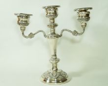 A silver three light candelabra, London 1977, the loaded base with foliate rims and branches,