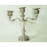 A silver three light candelabra, London 1977, the loaded base with foliate rims and branches,