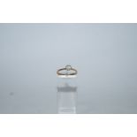 A single stone diamond ring, indistinctly stamped, the brilliant cut of approximately 0.