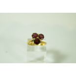 A three stone garnet ring, in a trefoil arrangement, finger size I, 3.