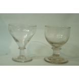 Two early 19th century glass rummers each raised on knopped stems and spayed feet,