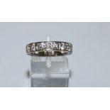 A nine stone diamond half hoop ring, stamped '18ct', the briliant cuts totalling approximately 1.