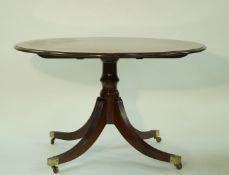 A 20th century round tilt top table,