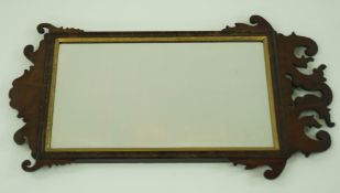 A George II style mahogany fret frame wall mirror, with gilt slip and bevelled glass plate,